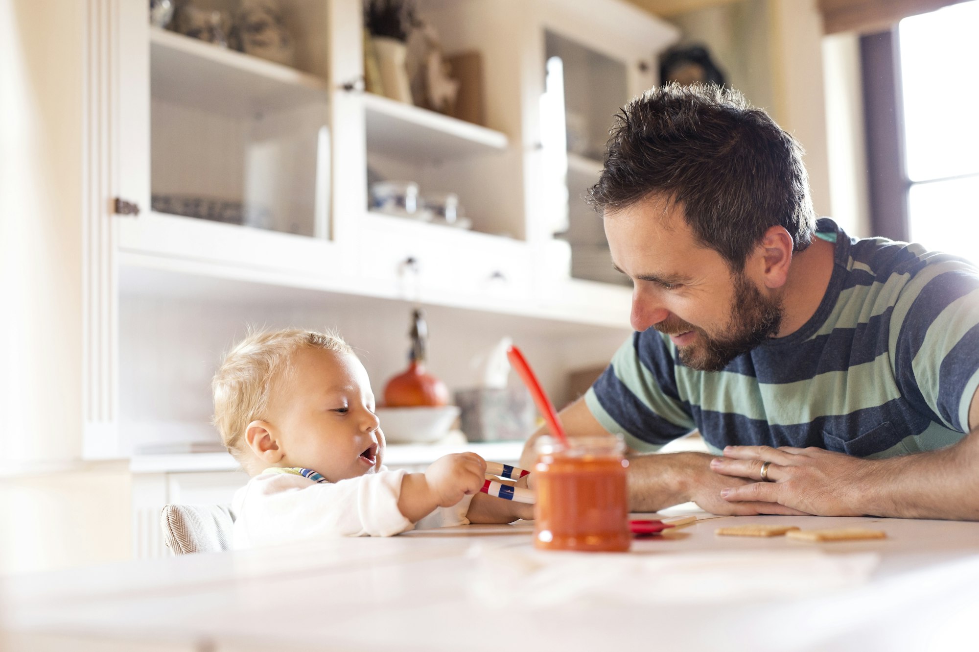 Father and baby at home at dining table