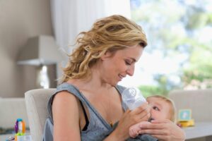 Mother bottle feeds baby