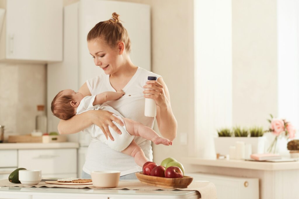 Young mother feeding baby